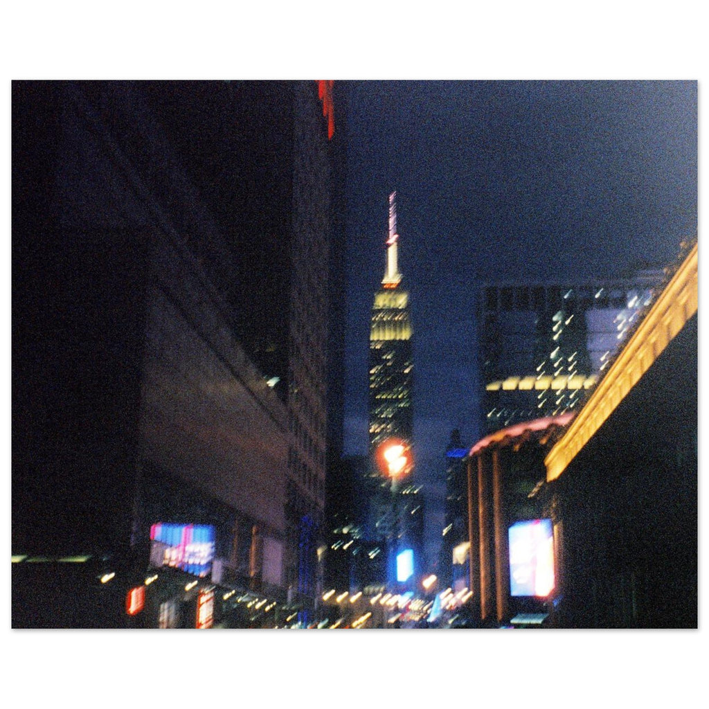 Nighttime 35mm film photograph of New York City 34th street lights with the Empire State Building in the distance.