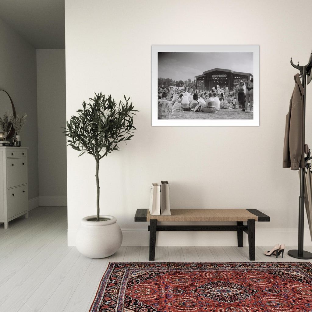 Black and white film photograph of a crowd at the Bonnaroo music festival facing the main stage.