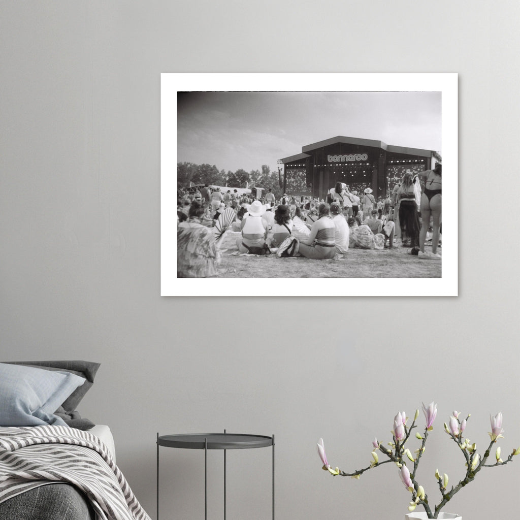 Black and white film photograph of a crowd at the Bonnaroo music festival facing the main stage.