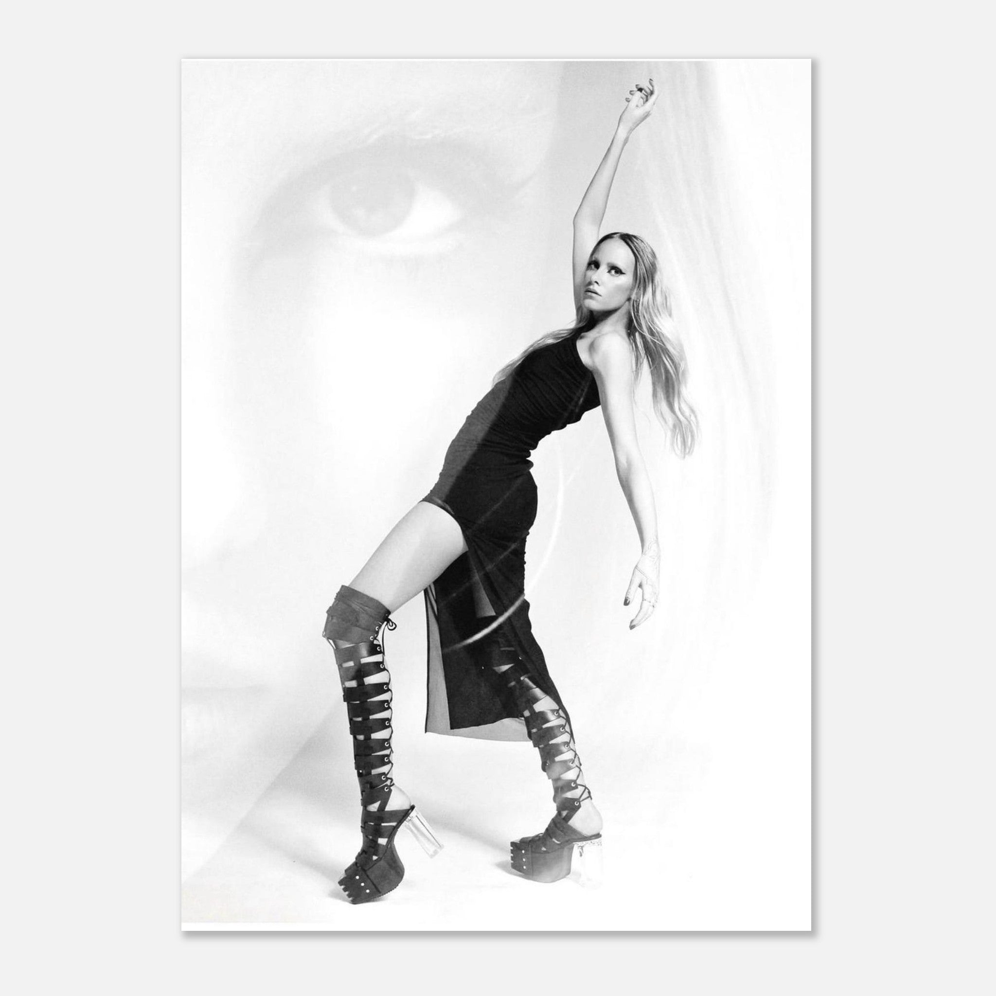 Black and white photo of a person posing with one arm raised on a plain background