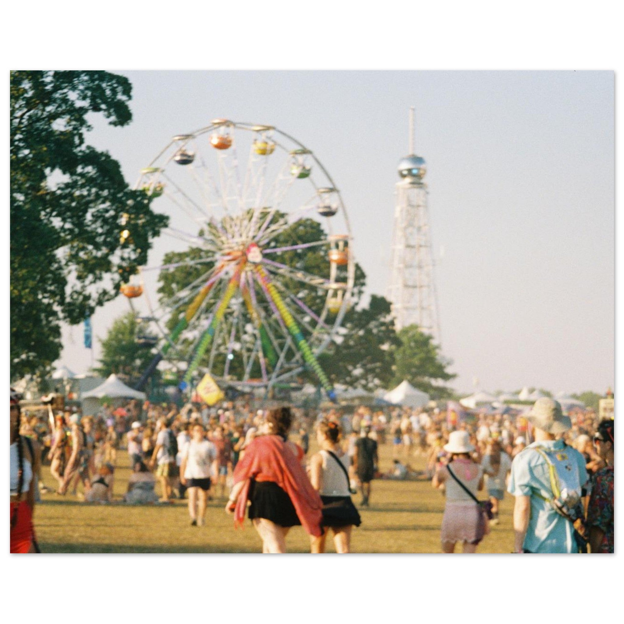Festival scene with a Ferris wheel and people in the foreground