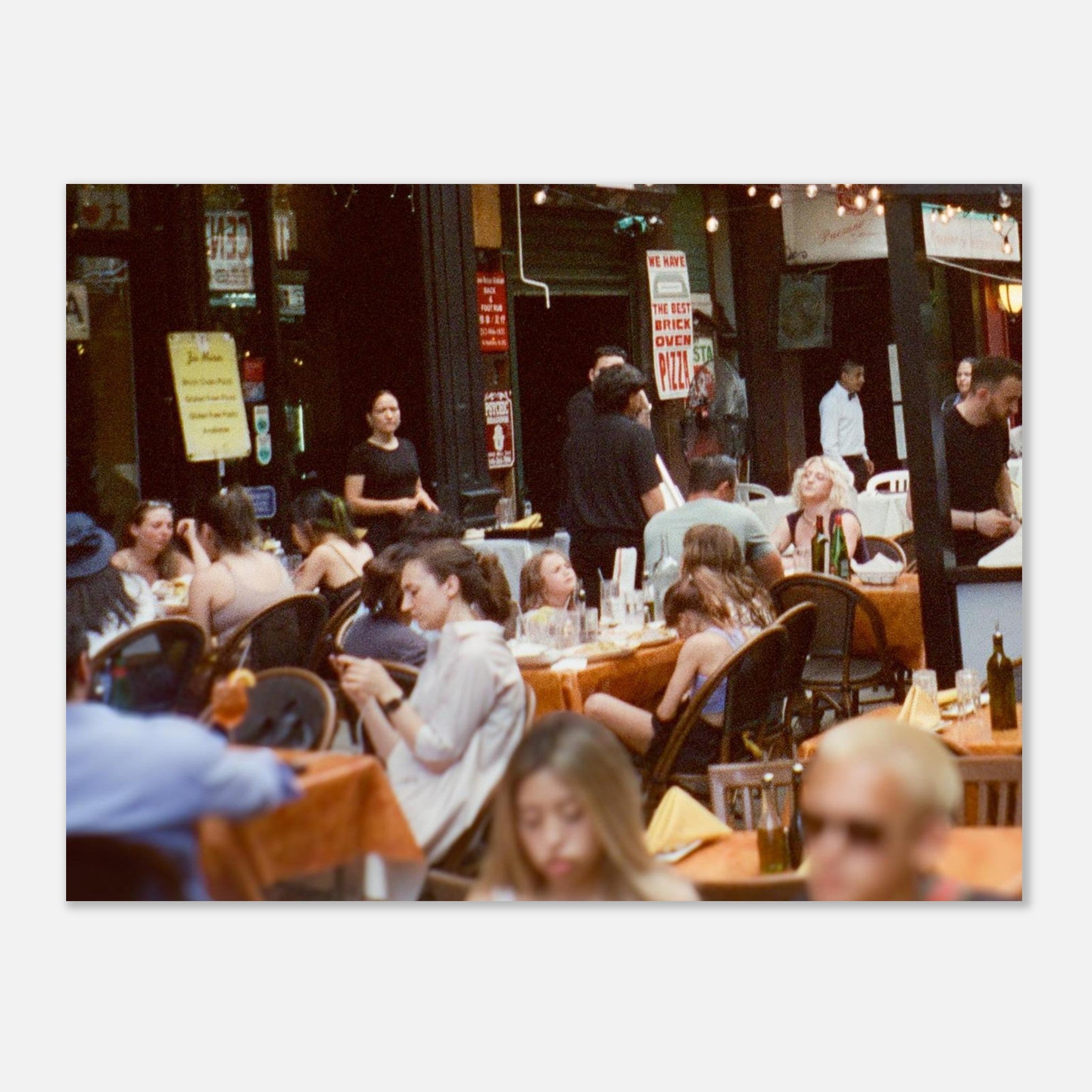 People dining in a restaurant with tables and chairs.