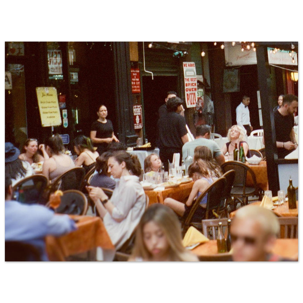 People dining at an outdoor restaurant with a lively atmosphere.