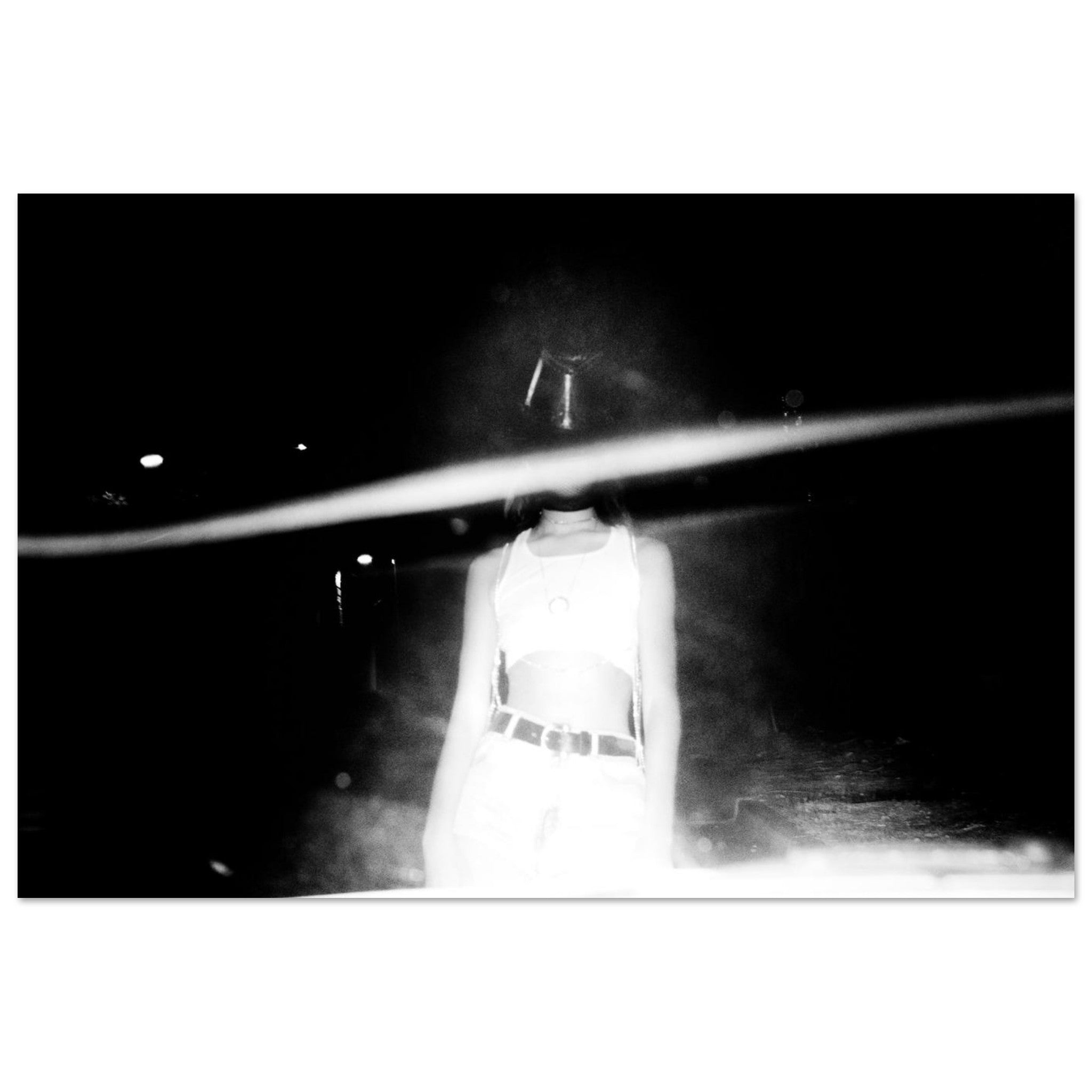 Person wearing a white outfit with a belt in a dark, possibly underwater setting.