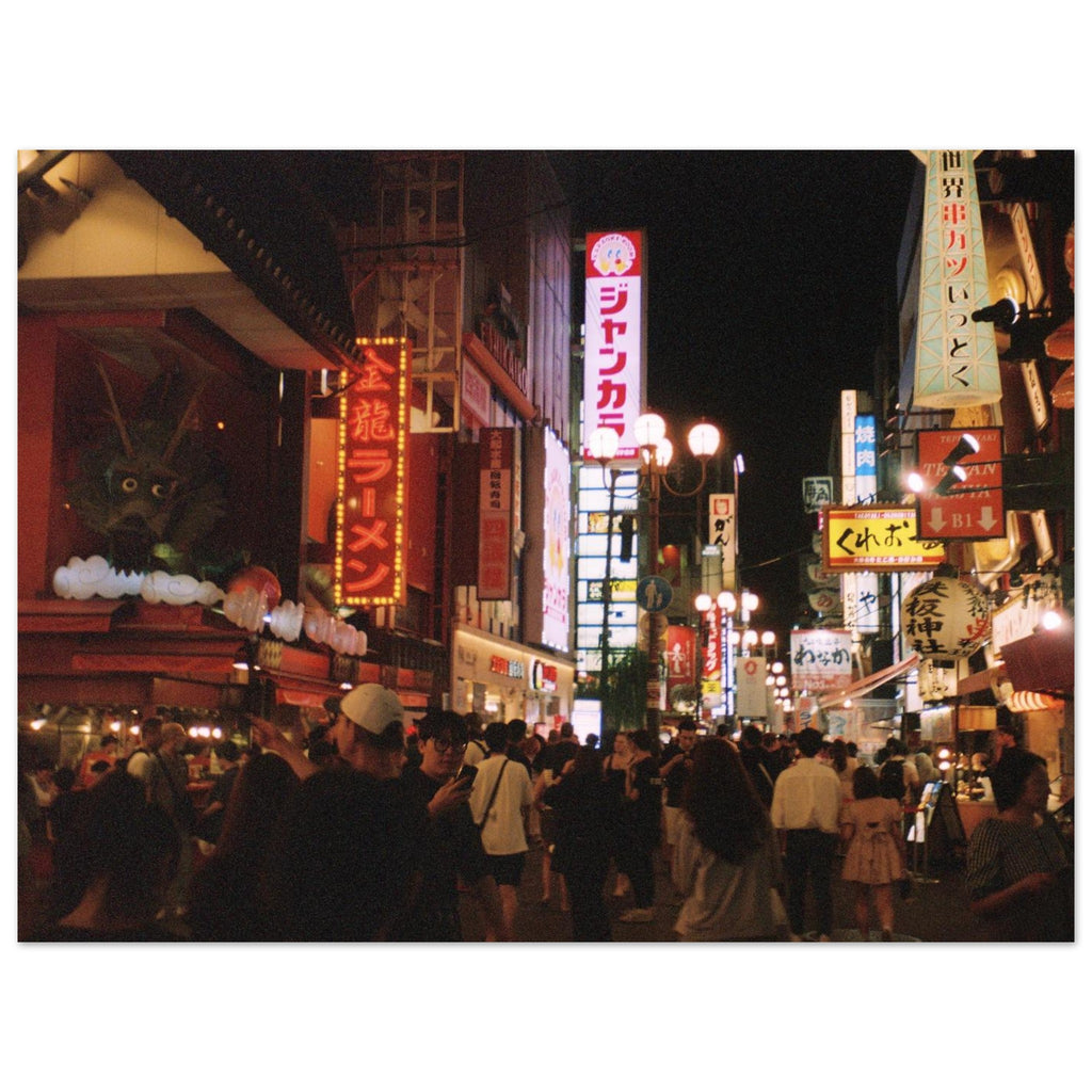 Film photograph of a busy Osaka night street filled with neon signs and crowds