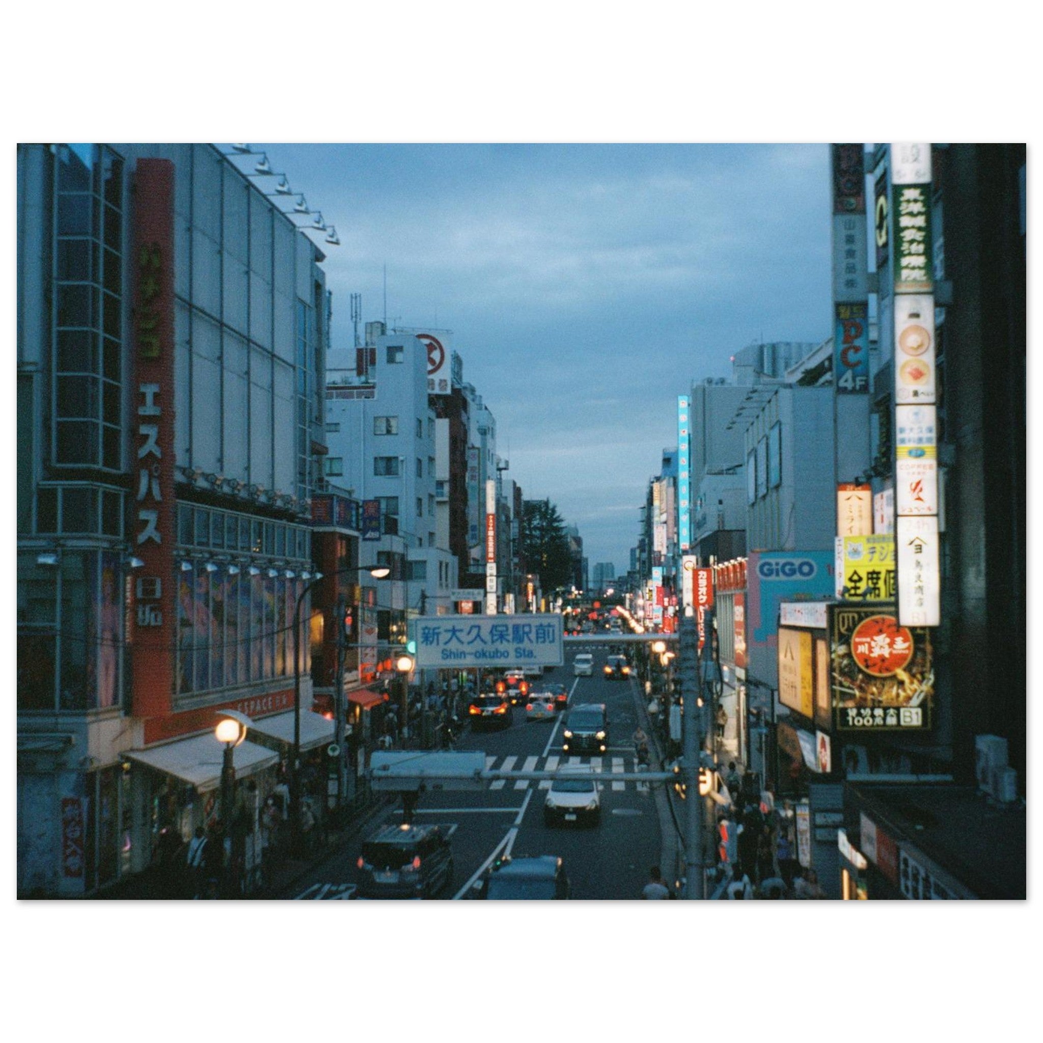 Film photo of a Tokyo street at dusk with buildings and traffic